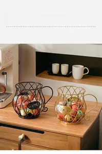 Detail of wire coffee pod holder in cup shape with metal COFFEE label and wooden surface