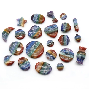 Assorted chakra natural stones in star, moon and heart shapes on white background