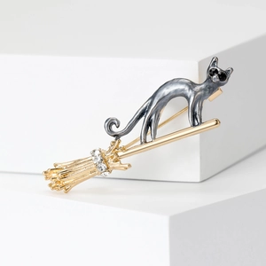 Fashionable cat on flying broom brooch with gold finish and sparkling rhinestones