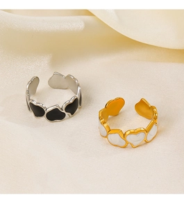 Detail of adjustable heart rings with black and white enamel in gold and silver finish