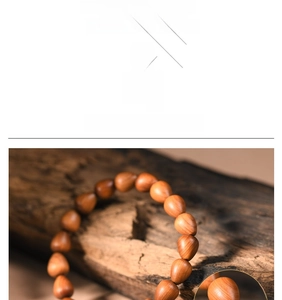 Macro detail of tear-drop cedar wood beads showing natural grain on rustic bark