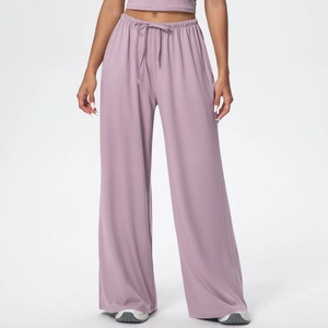 Detail of high waisted dusty mauve wide leg trousers with adjustable drawstring waistband