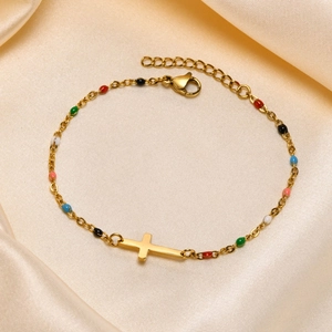 Gold stainless steel cross bracelet with colorful enamel beads on silk background