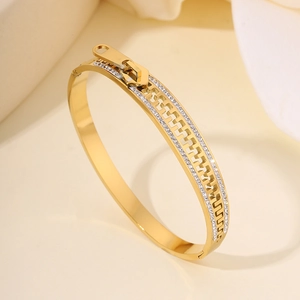Detailed view of golden stainless steel zipper bracelet with sparkling cubic zirconia stones
