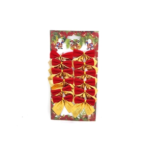 Macro detail of 12 red velvet and gold glitter Christmas bows on a display card