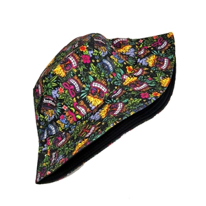 Detail of double-sided bucket hat featuring tropical Tiki mask and hibiscus flower prints