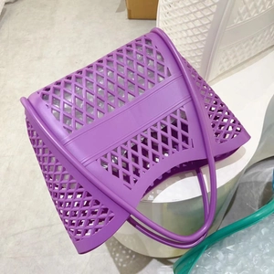 Close-up of purple hollow-out geometric silicone beach tote with net texture on display
