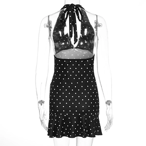 Close-up of black and white polka dot halter neck dress with ruffled hem detail