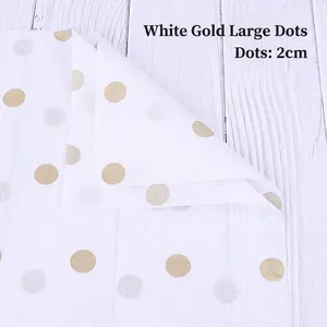 Detail of white tissue paper with 2cm gold dots for floral bouquet packaging