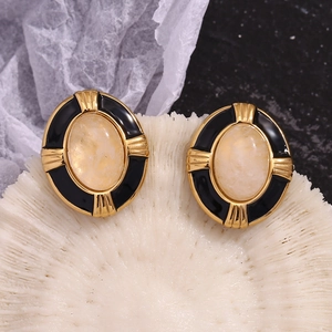 Macro detail of oval 18K gold plated earrings with vintage marble resin inlay