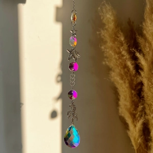 Detail of hanging crystal ornament with unicorn, stars, and teardrop prism crystal