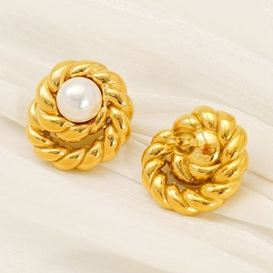 Detailed close-up of vintage twisted 18K gold titanium steel earrings with white pearl inlay