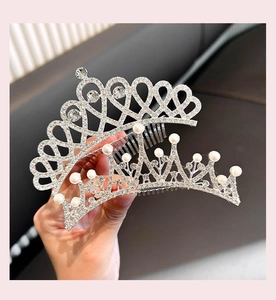 Detail of silver crown hair combs with white rhinestones and pearls for girls