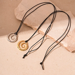 Minimalist spiral donut sweater necklace in gold and silver finish with black woven cord