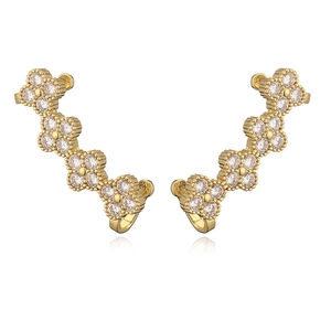 Close-up of four-leaf clover ear crawlers with sparkling zircon in a gold finish