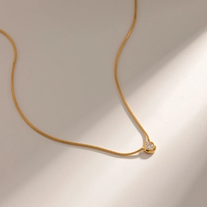 18K gold plated stainless steel snake chain necklace with round clear gemstone pendant
