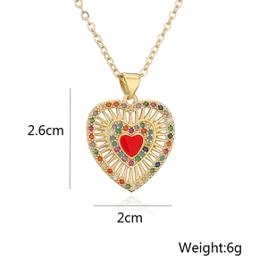 Detail of gold heart pendant with red zircon and dimensions of 2.6cm by 2cm and 6g weight