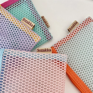 Detailed close-up of vibrant mesh pencil cases showing honeycomb texture and zippers