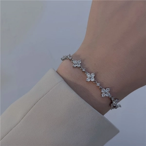 Detail of silver petal-shaped bracelet with cubic zirconia on a female wrist