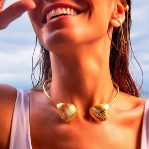 Detailed view of a golden starfish seashell choker necklace with textured metal details