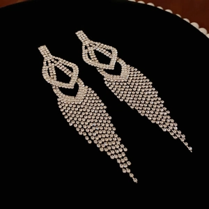 Detailed view of elegant silver long tassel earrings with sparkling rhinestones decoration