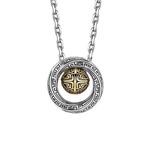 Macro detail of vintage Mobius ring necklace with engraved silver casing and gold core