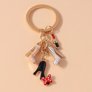 Detail of keychain featuring mini lipstick and polka dot stiletto shoe charms