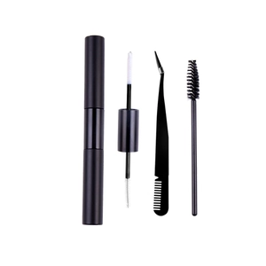 Detail view of 4-piece professional lash kit with dual-end glue, tweezers, and lash brushes