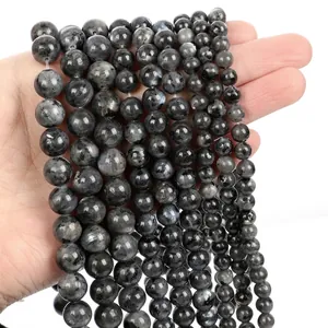 Multiple strands of polished natural labradorite round beads with unique stone textures