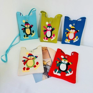 Handmade knitted penguin crossbody mini phone bags in five vibrant colors with snap closure