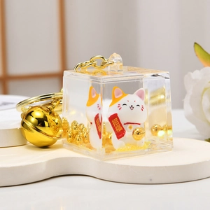 Golden liquid glitter lucky cat keychain in acrylic block with bell and charm