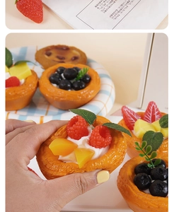Close-up of high-simulation PU fruit egg tart model with realistic berries and golden crust