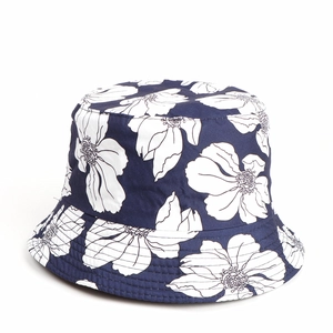 Detailed view of deep blue floral sun hat with white flower patterns and stitched brim