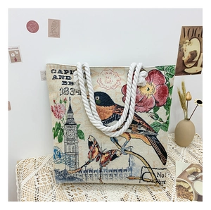 Detail of vintage bird and butterfly jacquard pattern on a white canvas tote bag