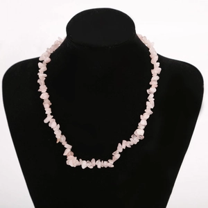 Close-up of pink quartz crystal chips necklace on a black mannequin display neck