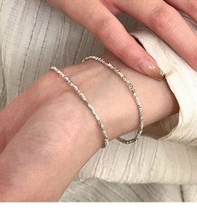 Close-up of S925 sterling silver crushed nugget beads bracelet on a woman wrist