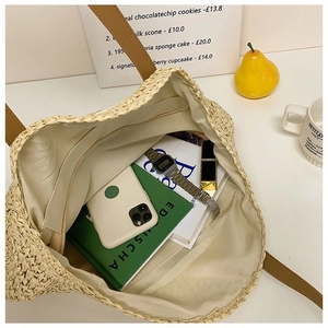 Interior view of large straw tote bag showing spacious storage for daily accessories