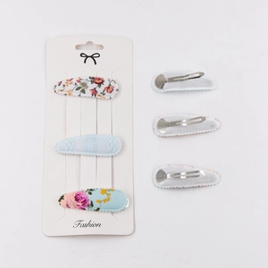 Detail of 6-piece floral fabric hair clips showing front patterns and back metal fasteners