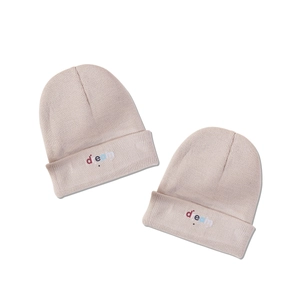 Beige knit beanie with colorful dream embroidery and star pattern for winter warmth
