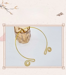 Detailed view of golden open neck ring with spiral swirl ends for DIY jewelry design