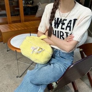 Vibrant yellow plush cosmetic bag featuring large capacity for travel makeup storage