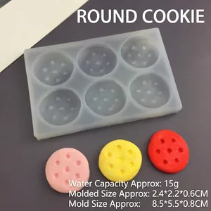 Detail of 6-hole round silicone cookie mold showing textured base and finished clay samples