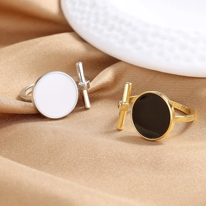 Anelli minimalisti in smalto bianco e nero con barra a T su elegante raso color champagne