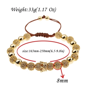 Detail view of gold braided bracelet with crystal beads and crown showing size parameters