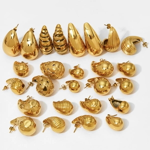 Various hollowed gold stainless steel teardrop and textured earrings on a white background