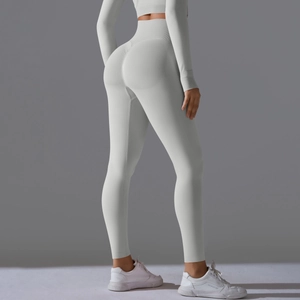 Detail view of seamless light gray leggings showing high waist and peach scrunch butt design