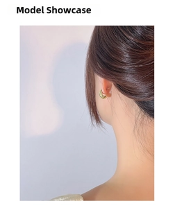 Polished gold crescent earrings on model showing minimalist geometric silver design