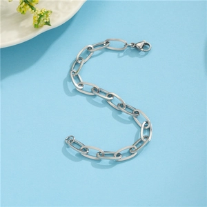 Flat oval link chain bracelet in silver finish with lobster clasp on blue background