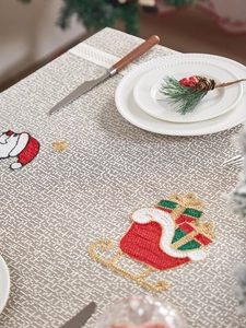 Close-up of Santa Claus embroidery on festive American style lace Christmas tablecloth