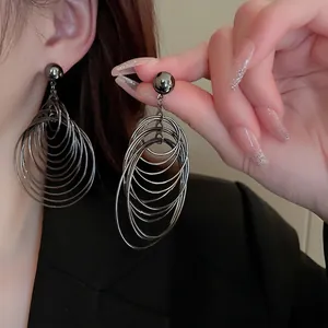 Minimalist multi-layered gunmetal hoop earrings with a sleek industrial sphere stud design